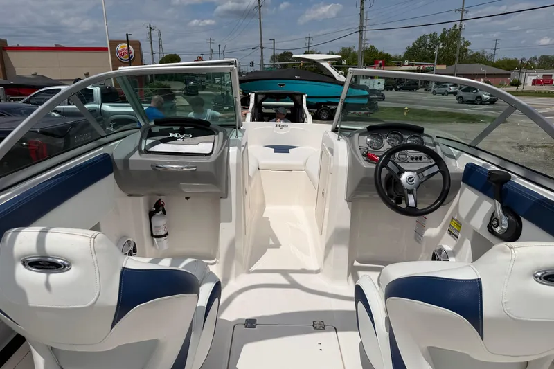 Slide: The Image of 2017 Chaparral 19 H2O Sport boat interior with steering wheel and seating. - 3