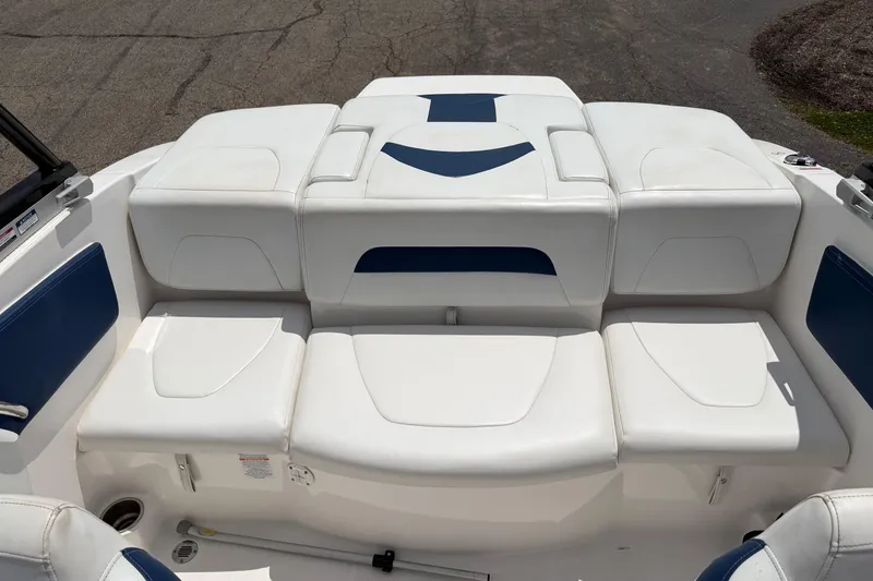 Slide: The Image of 2017 Chaparral 19 H2O Sport boat interior with white and blue cushioned seating. - 4