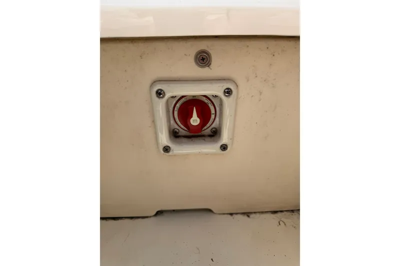 Slide: The Image of 2017 Chaparral 19 H2O Sport boat battery switch, red dial on white panel. - 5