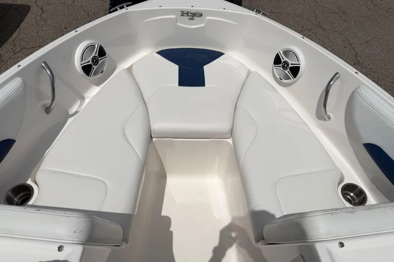Slide: The Image of 2017 Chaparral 19 H2O Sport boat interior with white seating and speakers. - 7