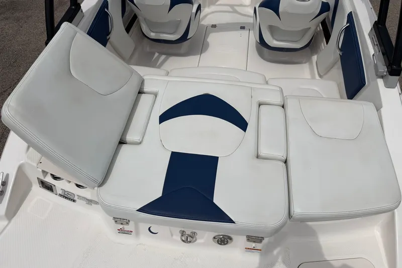 Slide: The Image of 2017 Chaparral 19 H2O Sport boat interior with white and blue seating arrangement. - 8
