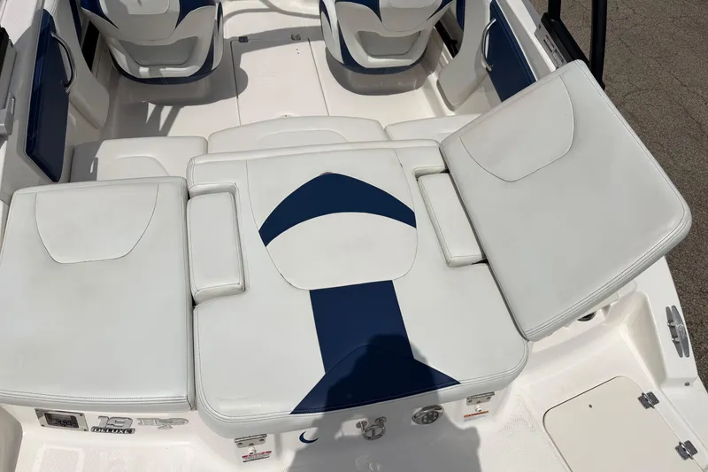 Slide: The Image of 2017 Chaparral 19 H2O Sport boat interior with white and blue seating. - 9