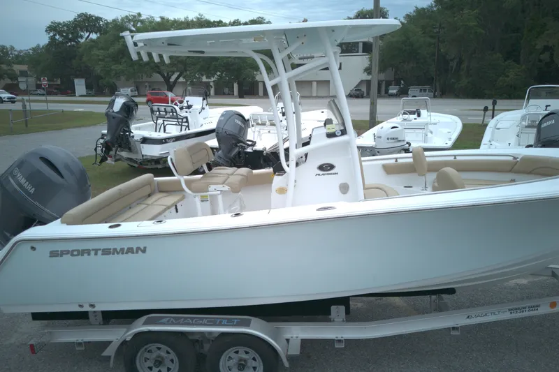 The Image of 2015 Sportsman Heritage 211 Center Console boat on trailer, featuring Yamaha outboard motor. - 0
