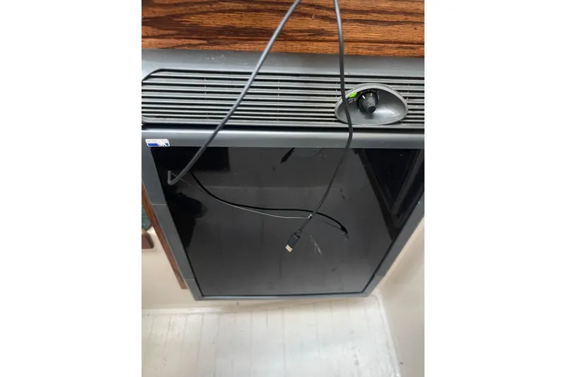 Slide: The Image of 1977 Catalina appliance with black front panel and visible cable. - 19