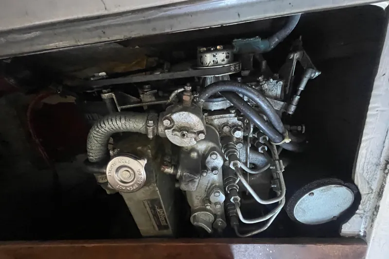 Slide: The Image of 1977 Catalina engine compartment with visible hoses and mechanical components. - 22