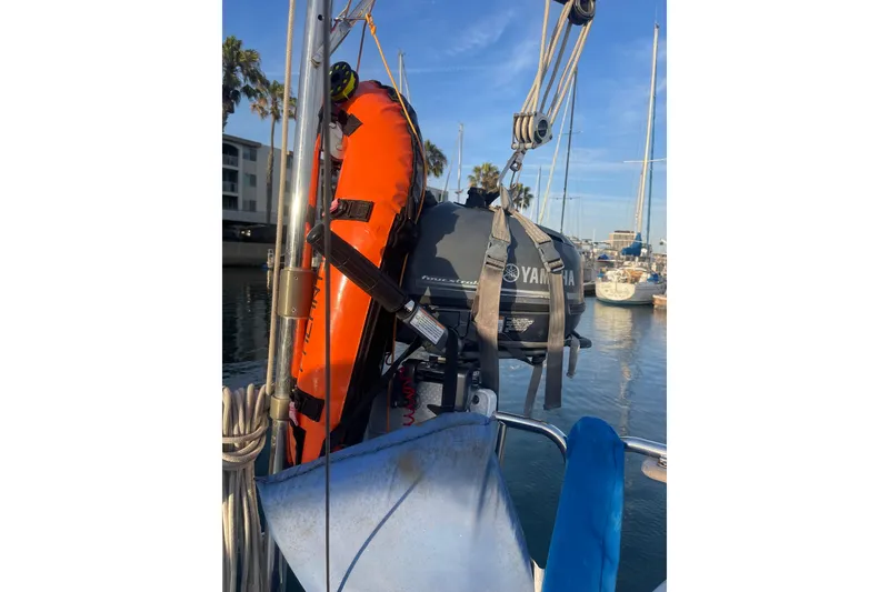 Slide: The Image of A 1977 Catalina boat with Yamaha motor and orange life preserver in a marina. - 6