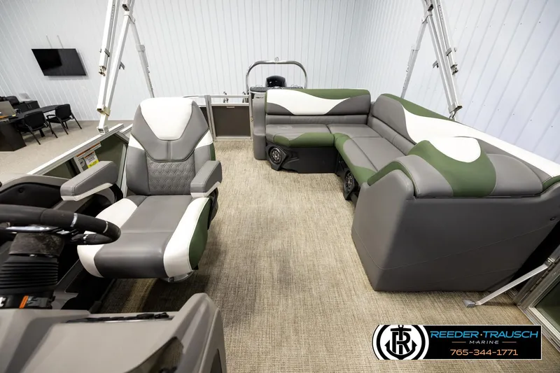 Slide: The Image of 2024 Avalon LSZ CRB boat interior with modern seating and steering wheel, displayed indoors. - 14