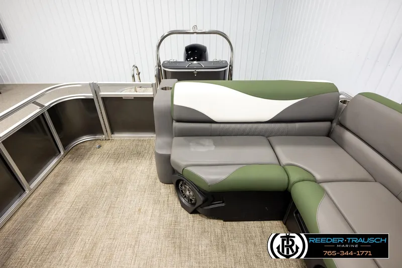 Slide: The Image of 2024 Avalon LSZ CRB pontoon boat interior with green and gray seating, Reeder-Trausch Marine logo. - 15