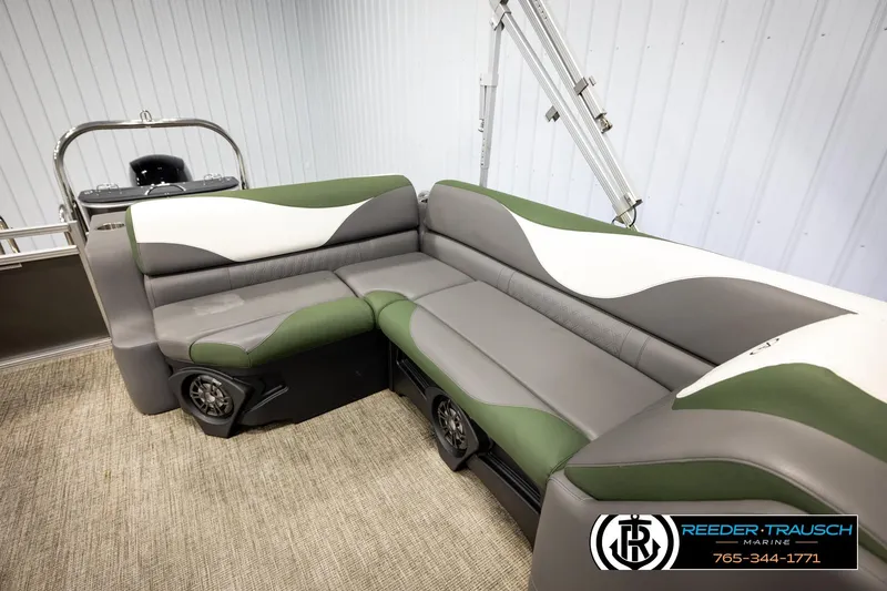 Slide: The Image of 2024 Avalon LSZ CRB boat interior with green and gray seating, featuring modern design. - 20