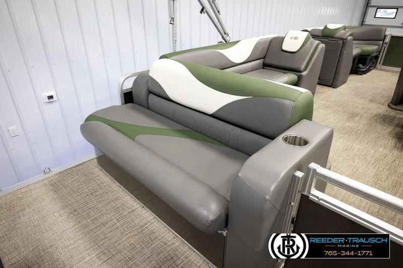 Slide: The Image of 2024 Avalon LSZ CRB boat interior with green and gray seating. - 22