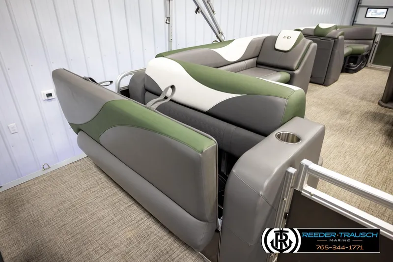 Slide: The Image of 2024 Avalon LSZ CRB boat interior with green and gray seating, cup holder, and modern design. - 23