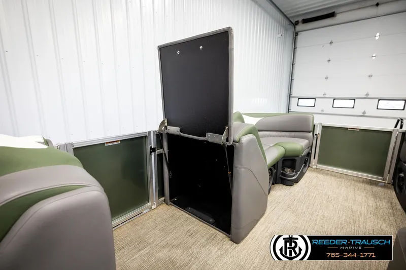 Slide: The Image of 2024 Avalon LSZ CRB boat interior with green and gray seating, open storage compartment. - 27