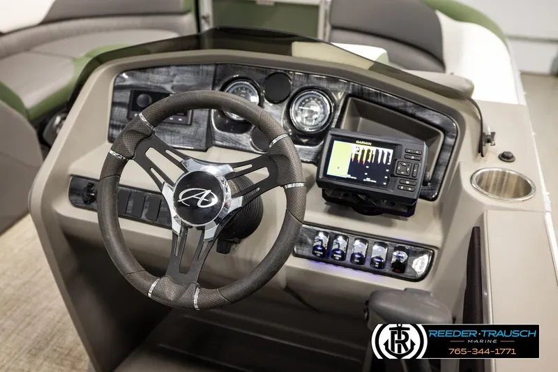 Slide: The Image of 2024 Avalon LSZ CRB boat dashboard with steering wheel and Garmin navigation system. - 28