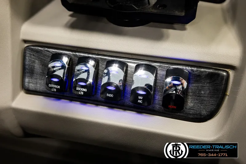 Slide: The Image of Control panel of 2024 Avalon LSZ CRB boat with illuminated switches for lights, radio, and horn. - 37