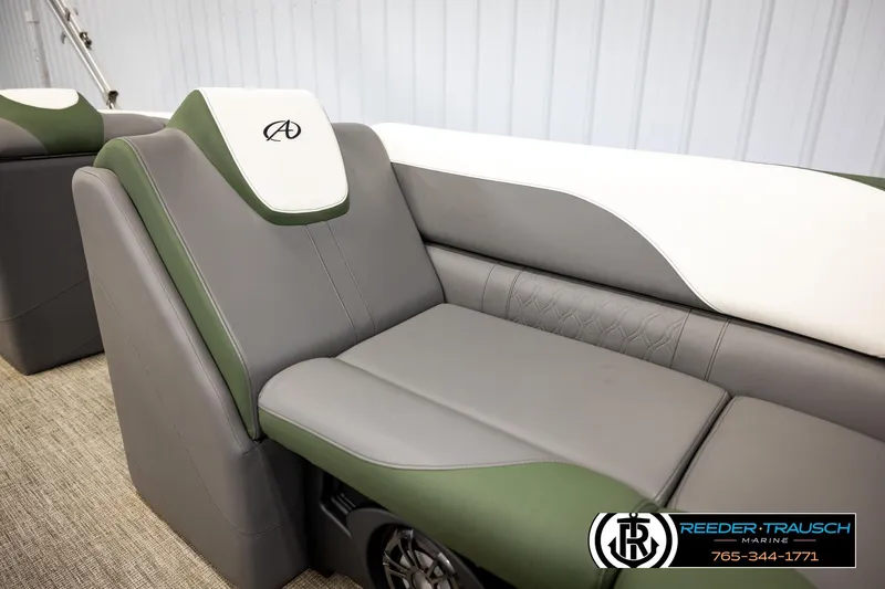 Slide: The Image of 2024 Avalon LSZ CRB boat seating with green and gray upholstery, featuring Reeder-Trausch Marine branding. - 40