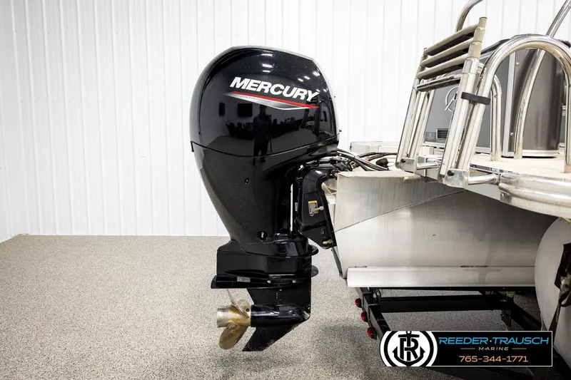 Slide: The Image of 2024 Avalon LSZ CRB with Mercury outboard motor in showroom setting. - 45