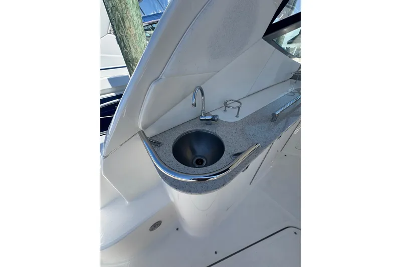 Slide: The Image of 2010 Searay 330 Sundancer boat sink with faucet on deck. - 10