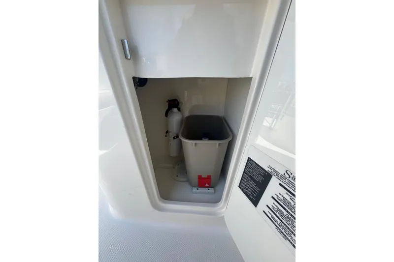 Slide: The Image of Storage compartment on a 2010 Searay 330 Sundancer with fire extinguisher and bin. - 11