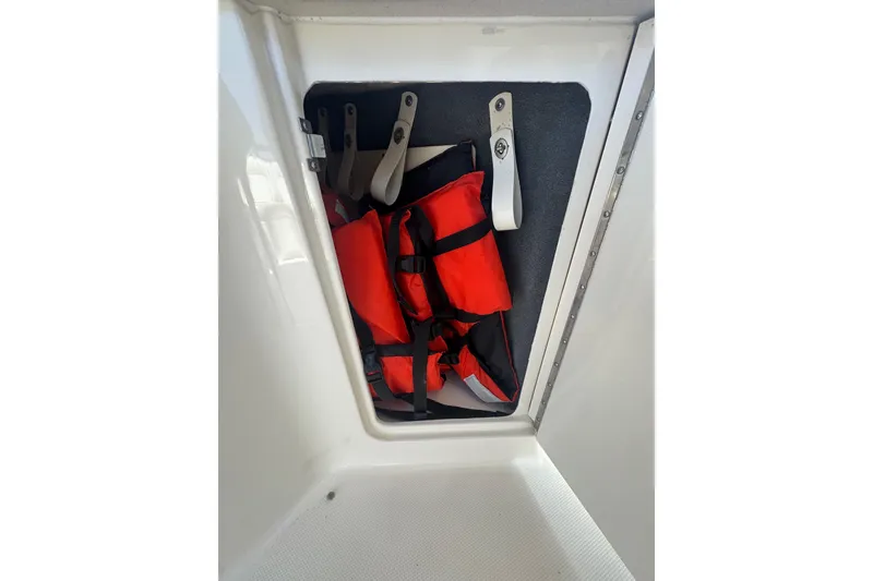 Slide: The Image of Storage compartment with life jackets on a 2010 Searay 330 Sundancer boat. - 14