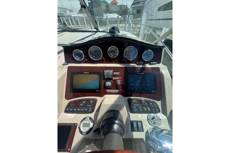 Slide: The Image of Cockpit of 2010 Searay 330 Sundancer with steering wheel and navigation instruments. - 17