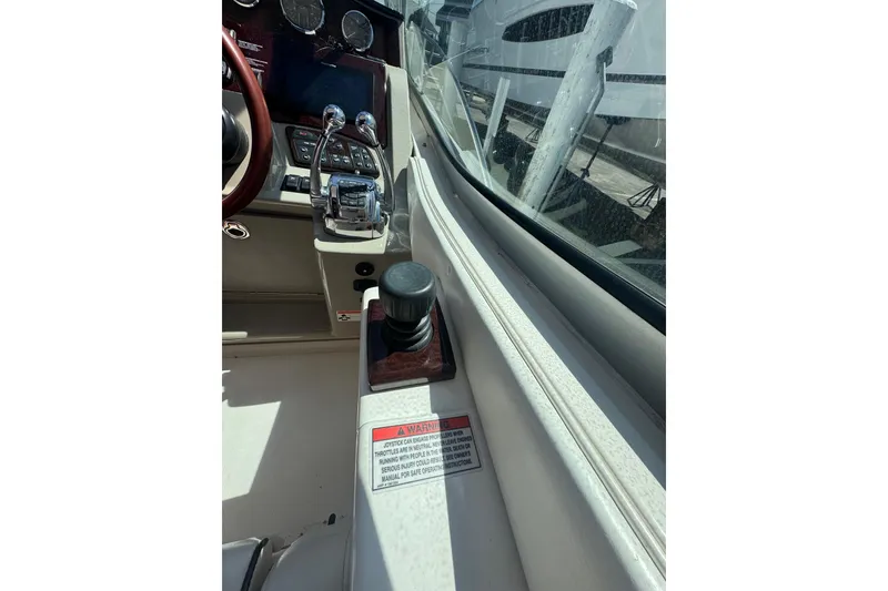 Slide: The Image of Cockpit view of 2010 Searay 330 Sundancer with navigation displays and controls. - 18