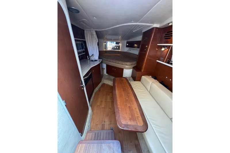 Slide: The Image of 2010 Searay 330 Sundancer yacht interior with seating and table at marina. - 21
