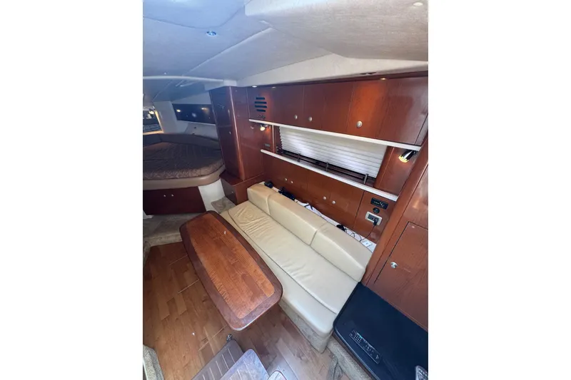 Slide: The Image of Interior of 2010 Searay 330 Sundancer yacht with cozy seating and wooden finishes. - 22