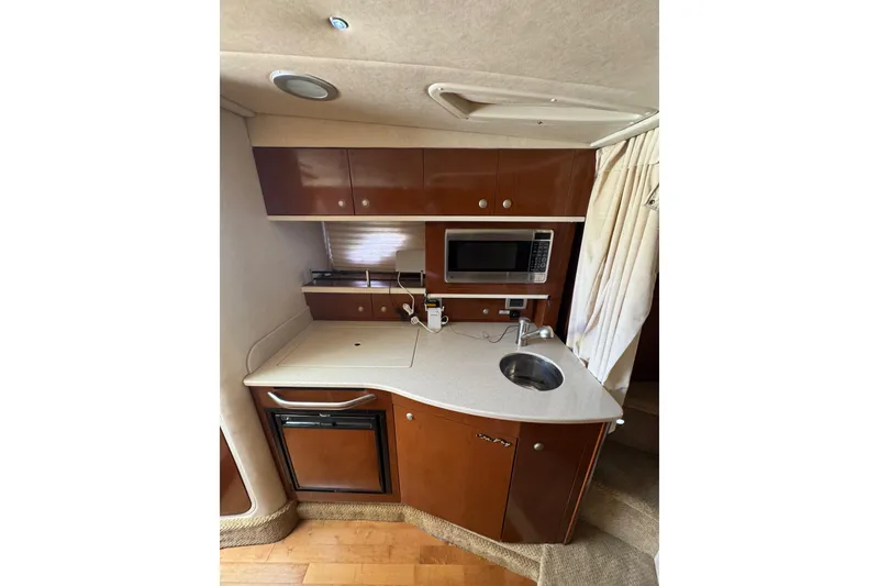 Slide: The Image of Compact bathroom in 2010 Searay 330 Sundancer yacht with sink and storage cabinets. - 26