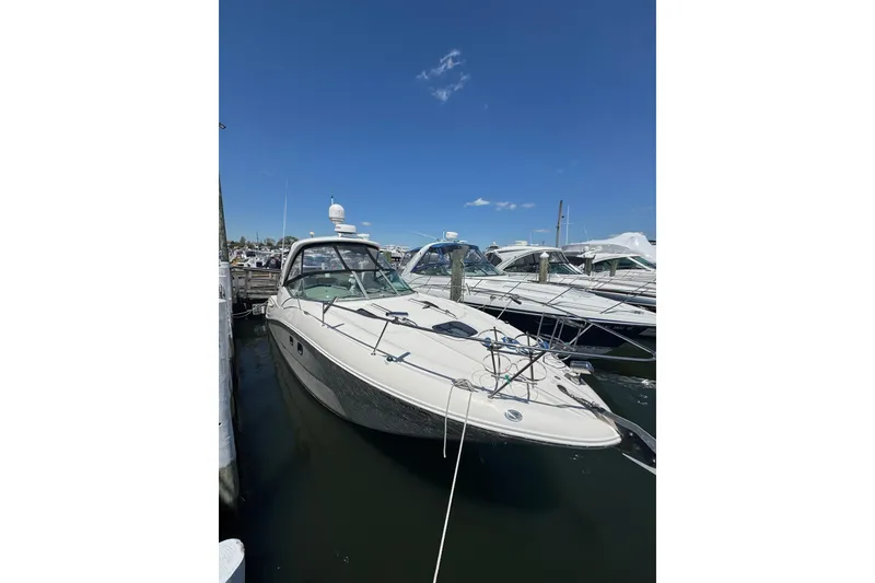 Slide: The Image of 2010 Searay 330 Sundancer yacht docked at marina under clear blue sky. - 3