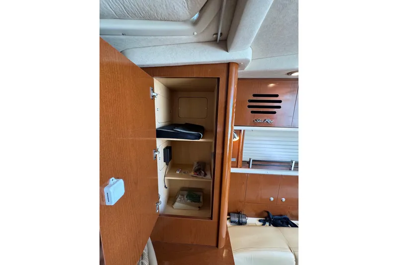 Slide: The Image of Life jackets stored in a wooden cabinet on a 2010 Searay 330 Sundancer boat. - 35
