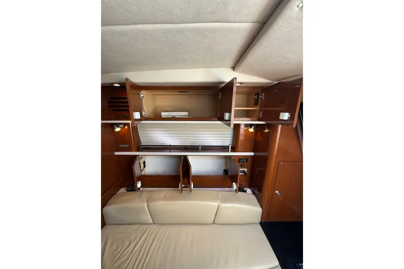 Slide: The Image of Interior cabinet of 2010 Searay 330 Sundancer yacht, showcasing storage space and wooden finish. - 36