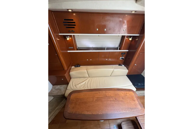 Slide: The Image of Open wooden cabinet with shelf inside a 2010 Searay 330 Sundancer boat. - 41