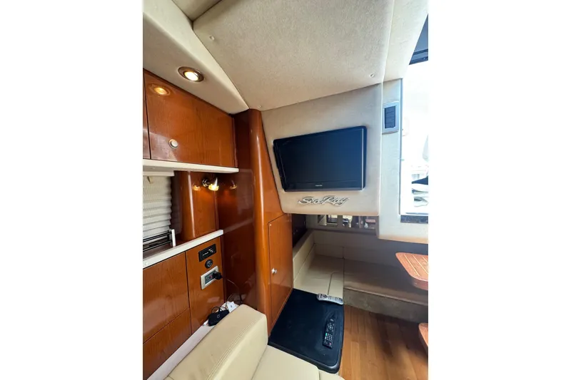 Slide: The Image of Interior of 2010 Searay 330 Sundancer with wooden cabinetry and beige seating. - 42