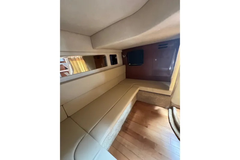 Slide: The Image of Interior of 2010 Searay 330 Sundancer yacht with TV and wooden cabinetry. - 43