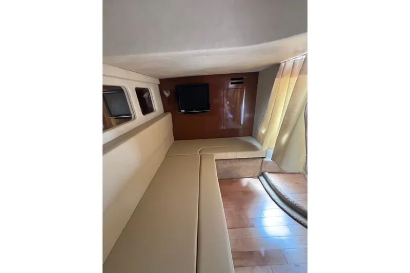 Slide: The Image of Interior cabin of 2010 Searay 330 Sundancer with beige seating and wood flooring. - 44