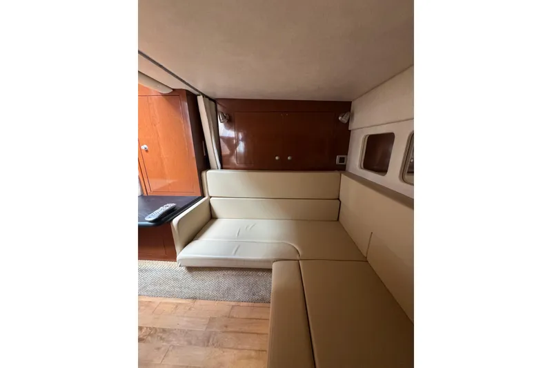 Slide: The Image of Interior of 2010 Searay 330 Sundancer yacht with beige seating and wall-mounted TV. - 45