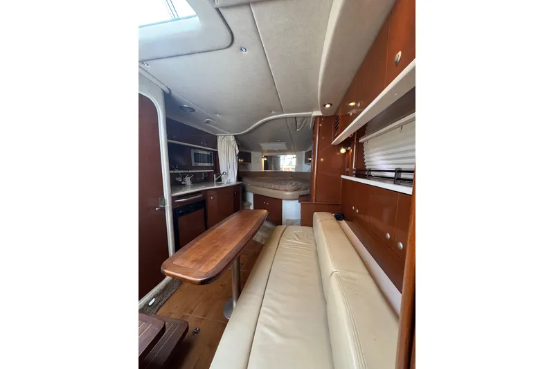 Slide: The Image of Interior of 2010 Searay 330 Sundancer yacht with beige seating and wooden cabinetry. - 46