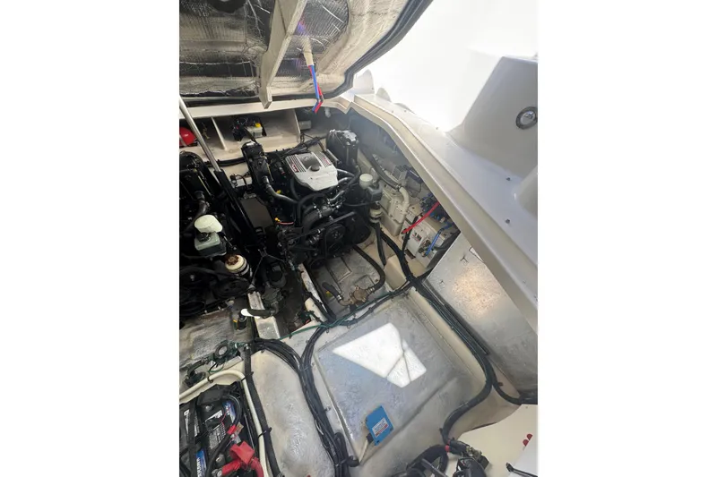 Slide: The Image of Engine compartment of 2010 Searay 330 Sundancer boat, showcasing mechanical components and wiring. - 53