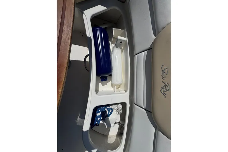 Slide: The Image of Storage compartment on 2010 Searay 330 Sundancer boat with blue and white items. - 8
