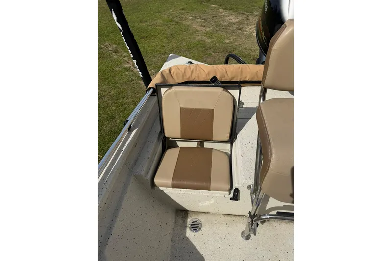Slide: The Image of 2023 Xpress H20B Bay boat with tan seating and deck view. - 13