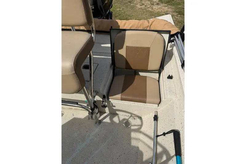 Slide: The Image of 2023 Xpress H20B Bay boat interior with tan seating and fishing rod holder. - 14