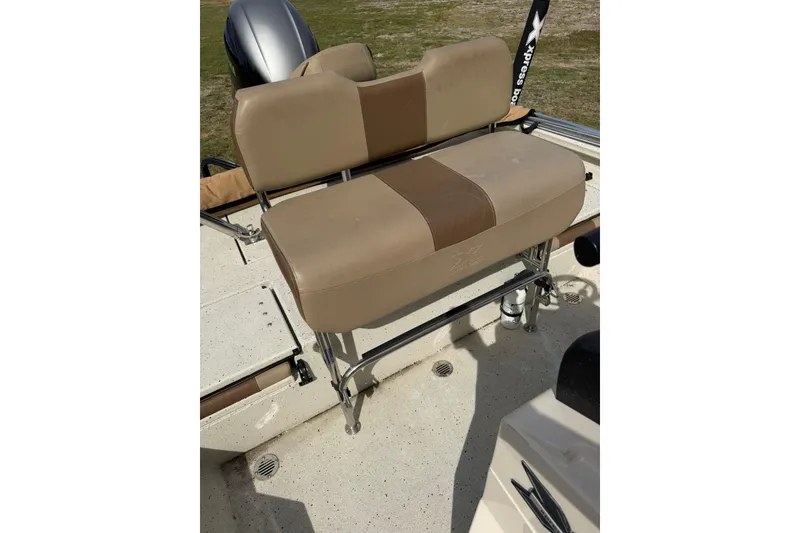 Slide: The Image of 2023 Xpress H20B Bay boat with tan seating and stainless steel frame. - 15