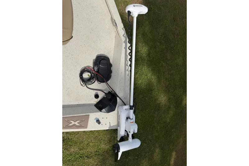 Slide: The Image of 2023 Xpress H20B Bay boat with trolling motor on grass. - 16
