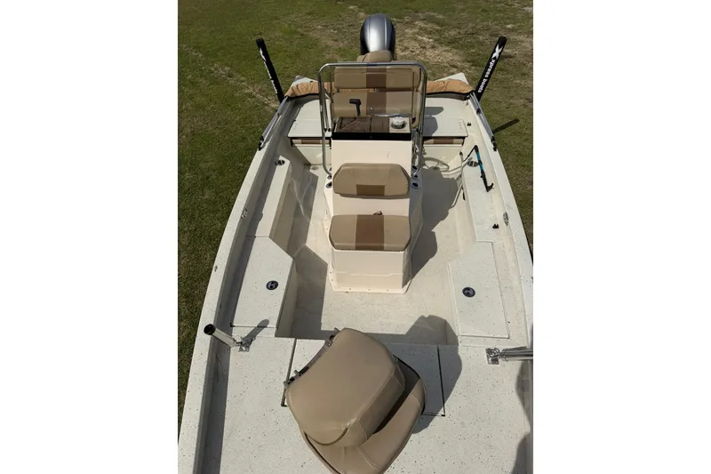 Slide: The Image of 2023 Xpress H20B Bay boat interior with beige seating and steering console. - 17