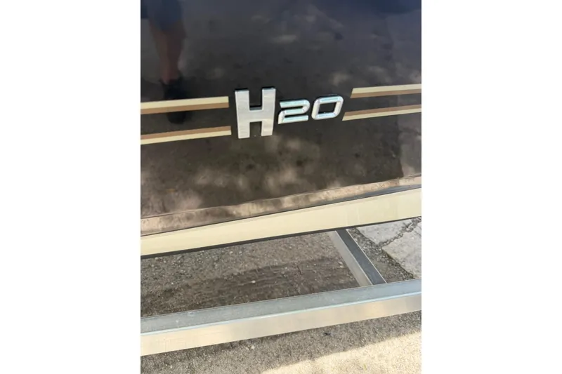 Slide: The Image of 2023 Xpress H20B Bay boat emblem on a metallic surface. - 18