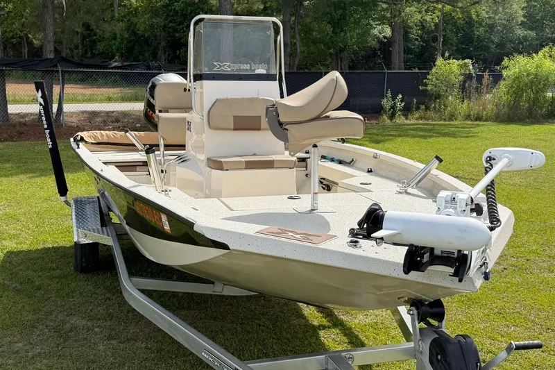 Slide: The Image of 2023 Xpress H20B Bay boat on trailer, parked on grass, featuring modern design and equipment. - 3