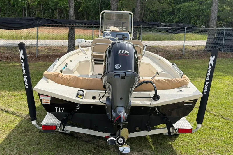 Slide: The Image of 2023 Xpress H20B Bay boat with Yamaha 115 engine, parked on grass. - 5