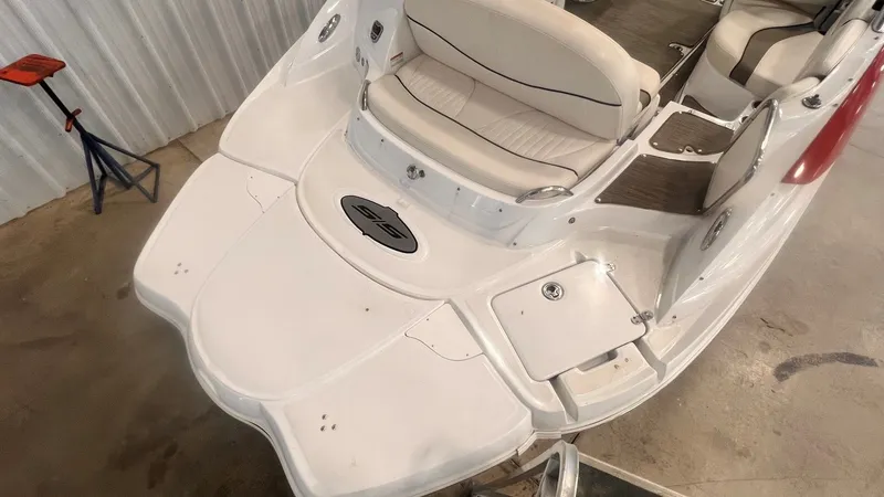 Slide: The Image of 2013 Cruisers Yachts 258 Sport Series boat rear view in a garage. - 13