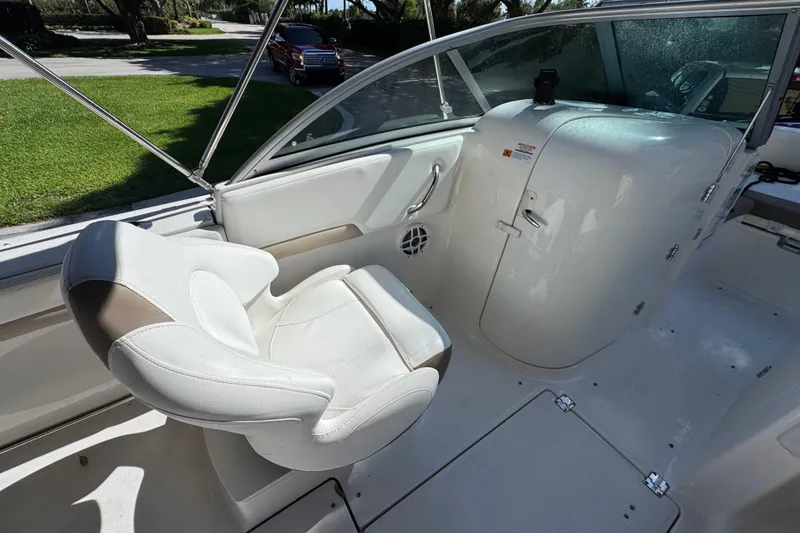 Slide: The Image of 2022 Robalo R207 Dual Console boat interior with white seating and helm station. - 10