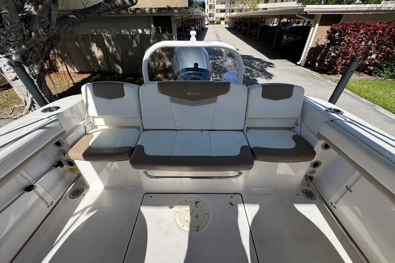 Slide: The Image of 2022 Robalo R207 Dual Console boat interior with cushioned seating and storage compartments. - 5